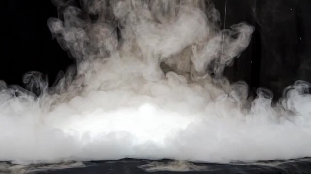 Thick white smoke rising from dry ice, sublimation process on black background
