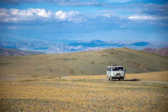 Russian UAZ van driving on a dirt track through the Altai Mountains, Western Mongolia