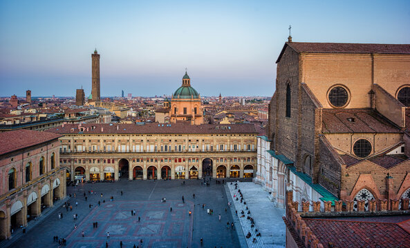 Panoramic evening view of Piazza Maggiore and the Basilica di San Petronio in Bologna, Italy, seen from the clock tower.