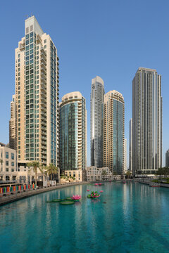 Modern Architecture of Dubai Opera House with Dhow-Inspired Glass Design, Surrounded by Palm Trees and Downtown Skyscrapers under Clear Blue Sky, Dubai, UAE