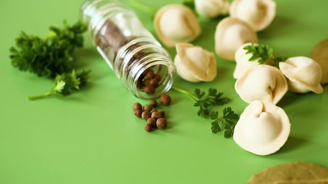 Fresh homemade dumplings with pepper parsley and bay leaves