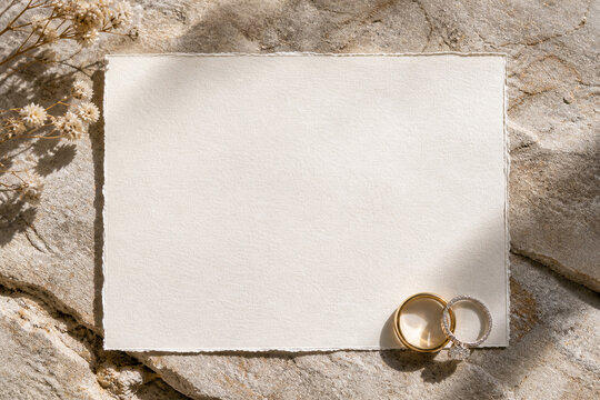 Elegant Wedding Invitation Mockup with Rings on Natural Stone Surface