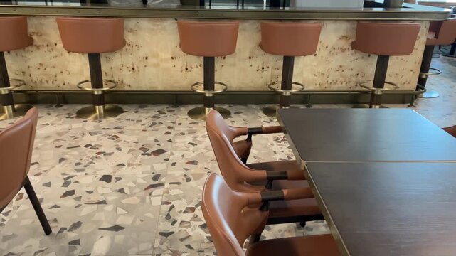 Empty bar interior with brown chairs and terrazzo floor, suitable for restaurant background