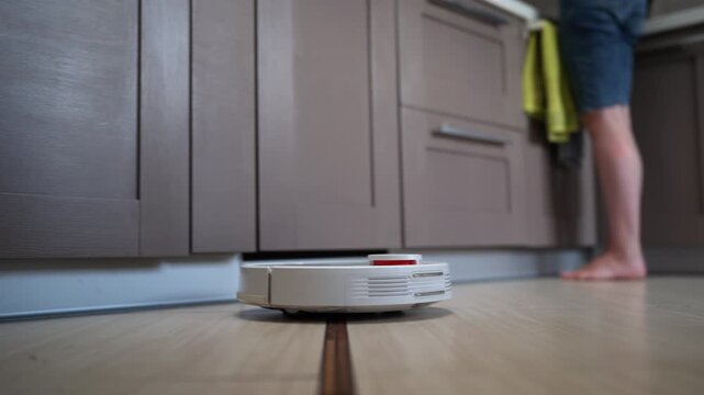Robot Vacuum Cleaner efficiently moves and cleans tile floor. The device maneuvers autonomously, providing a thorough cleaning of the surface.