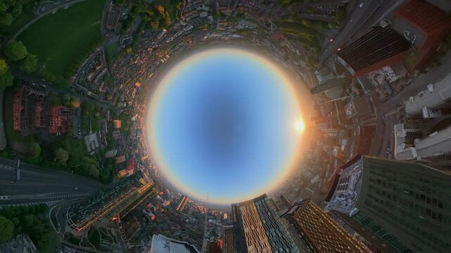 A creative spherical video of modern glass towers and the urban landscape of Manchester during a clear golden sunrise..