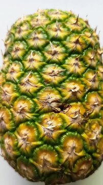Whole fresh pineapple ananas comosus fruit texture isolated on white background