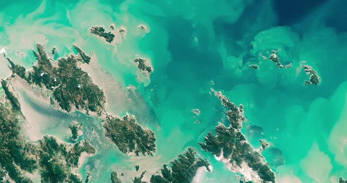 Top shot on aquaculture in sea near coast. Camera is zooming out. Animation based on image by NASA