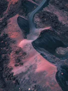 Aerial view of volcanic terrain with winding river at dusk