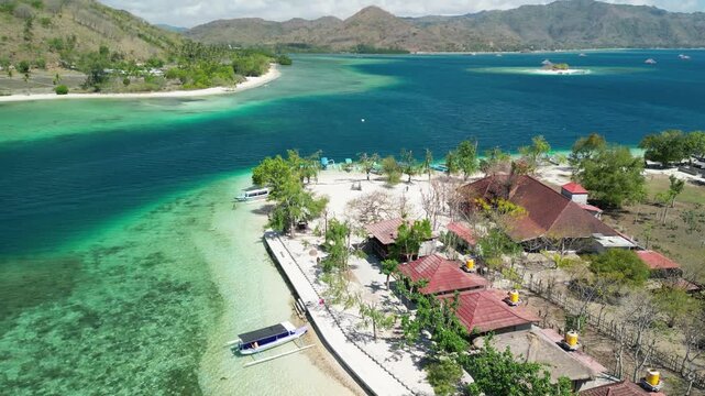 Stunning overhead panorama Gili Sudak secret islet featuring crystal clear waters coral reefs and lush green vegetation backdrop