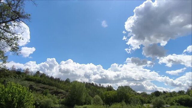 Peaceful countryside in summer. Smooth camera movement with blue sky and clouds