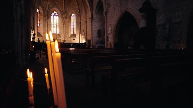 Issigeac Church Interior with Burning Candles and Light Rays