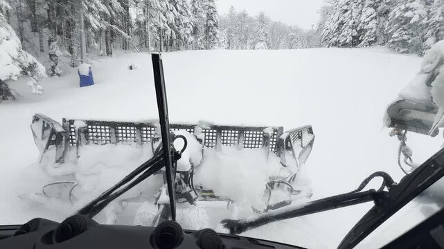 Snow Groomer Prepares a Pristine Ski Slope for Winter Sports at a Mountain Resort