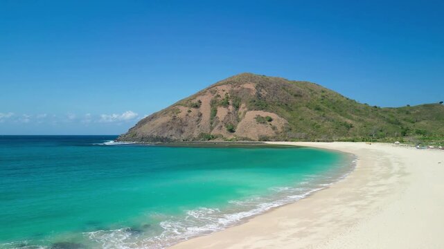 Stunning overhead panorama of Pantai Mawun near Kuta featuring calm lagoon fishing boats and pristine tropical shoreline