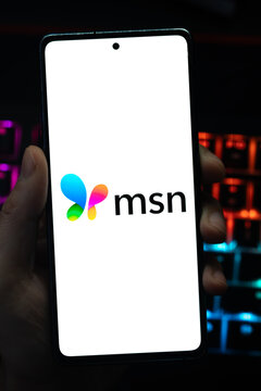 Punta Arenas, Chile &ndash; May 04, 2026: A person's hand holds a mobile smartphone displaying the colorful butterfly icon and black msn logo on a white screen, set against a dark background 