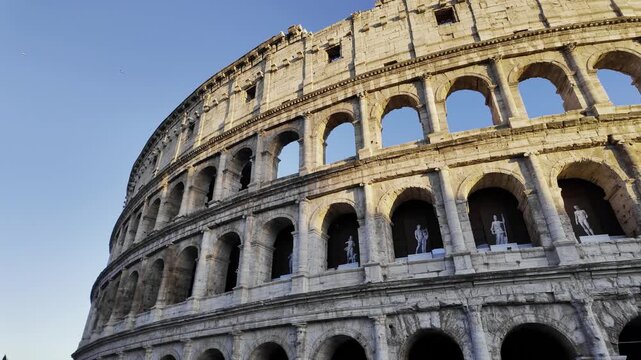 4K Panoramic low angle view of the Colosseum in Rome at golden hour, Italy