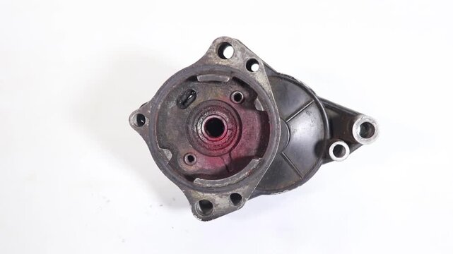Close-up stock footage of an automotive wheel hub rotating slowly against a white background, showcasing its mechanical function and components