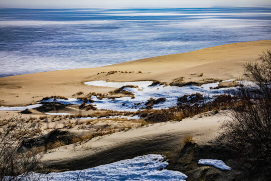 Winter landscape of sand dunes on the Curonian Spit near the frozen sea coast