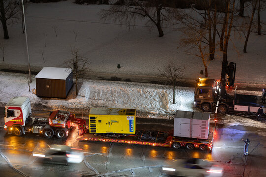 Kyiv, Ukraine &ndash; Jan 29, 2026: State Emergency Service of Ukraine personnel transfer industrial diesel generator for deployment after destruction of Darnytska CHP 4 plant in Darnytskyi district area.