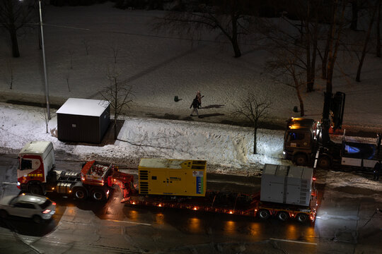 Kyiv, Ukraine &ndash; Jan 29, 2026: State Emergency Service of Ukraine personnel transfer industrial diesel generator for deployment after destruction of Darnytska CHP 4 plant in Darnytskyi district area.