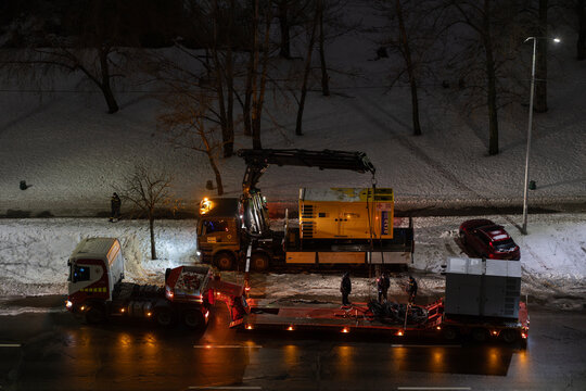 Kyiv, Ukraine &ndash; Jan 29, 2026: State Emergency Service of Ukraine personnel transfer industrial diesel generator for deployment after destruction of Darnytska CHP 4 plant in Darnytskyi district area.