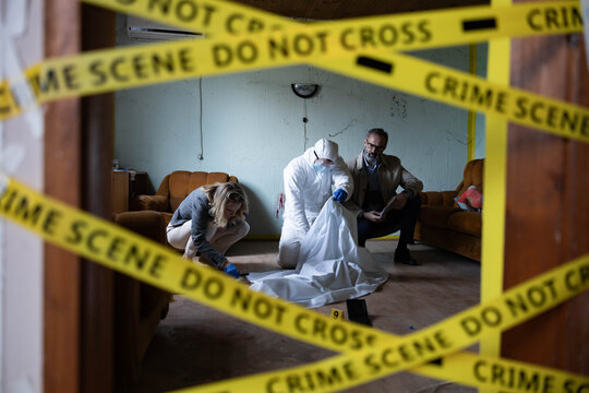 Forensic specialist and detectives examining evidence at a cordoned-off crime scene, investigating a serious criminal case