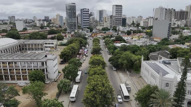Drone flies up Rua dos Lusiadas toward downtown on an overcast day in Maputo, Mozambique