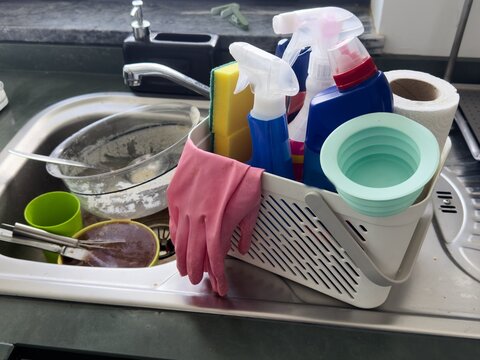 Plastic basket with cleaning supplies, closeup