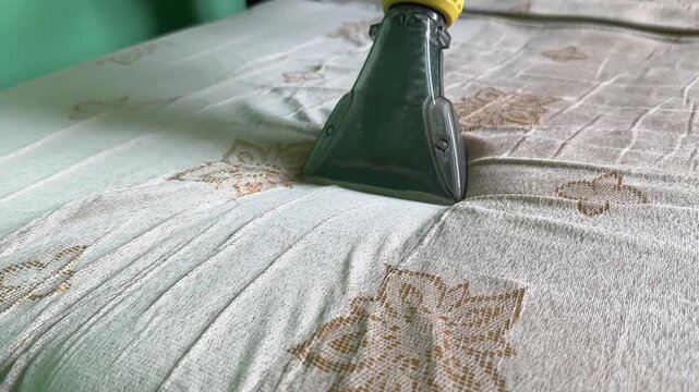 Cleaning a Mattress with a Steam Cleaner in Action