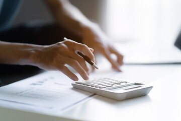 Fototapeta premium Man reviews tax invoices at home to manage her financial planning