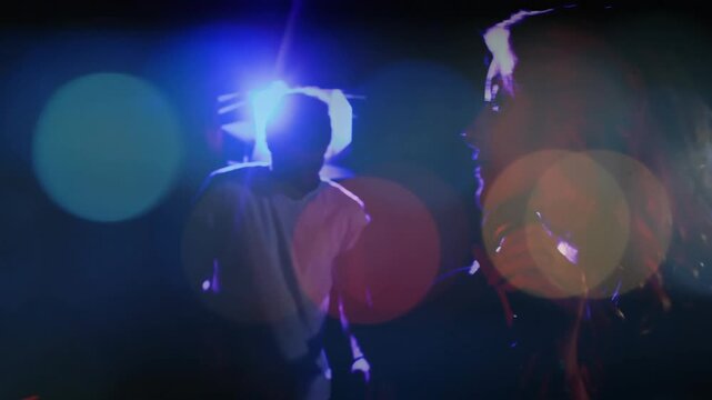 Backlight cueing female singer forward, holding mic, singing; lens flares and bokeh accenting music