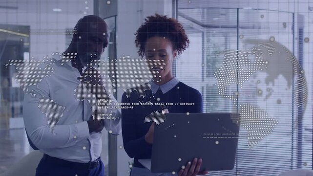 Woman offering laptop, presenting data analytics to man as dotted world map streaming across glass
