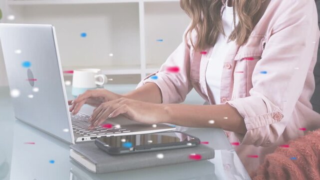Woman placing hands on laptop, typing for remote work while particles partly hiding hands phone
