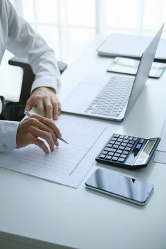 Auditor reading a report documents in office