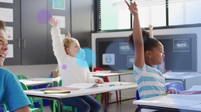 Front-right girl raising hand on teacher cue in classroom, blue or purple circles appearing over des