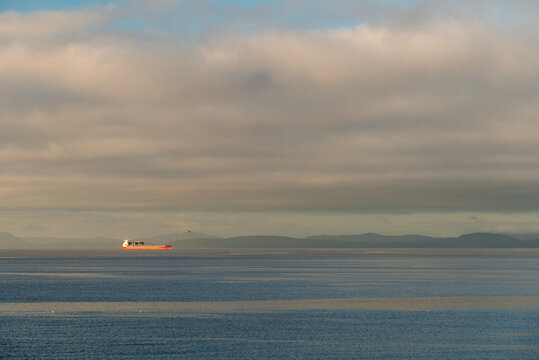 Canada, BC, Salish Sea.  A freighter traveling through the Inside Passage between Vancouver Island and the Mainland of British Columbia.