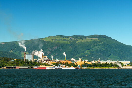 Canada, BC, Crofton.  Pulp and paper mill on the eastern shore of Vancouver Island.  The evidence of clear-cut logging visible on the distant hills.
