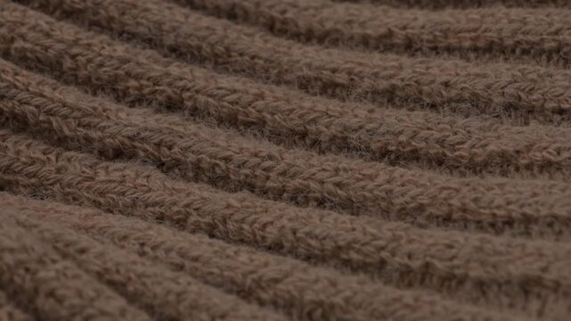 knitted brown of textile woollen fabric close up background