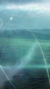 Vertical video: Sunrise glow sparking HUD rings sweeping over pipe and field, showing data patterns