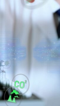 Vertical video: Lab scientist placing vials causing icons showing CO2 environmental data