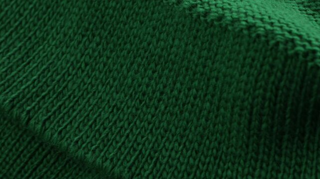rotation of knitted green wool textile warm winter clothing