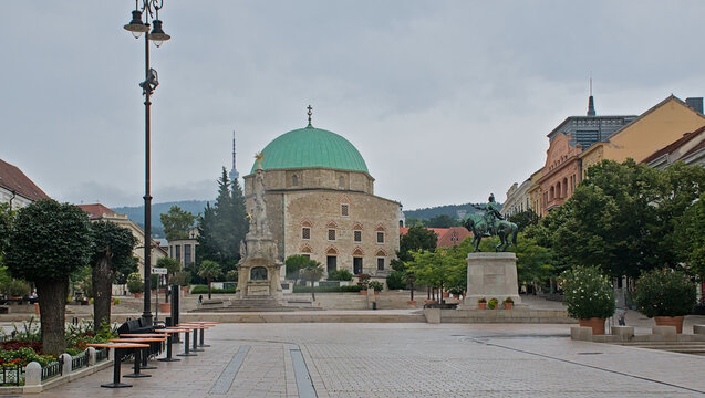 Downtown Candlemas Church of the Blessed Virgin Mary, Mosque of Pasha Qasim on a cloudy day in Pecs, Hungary 