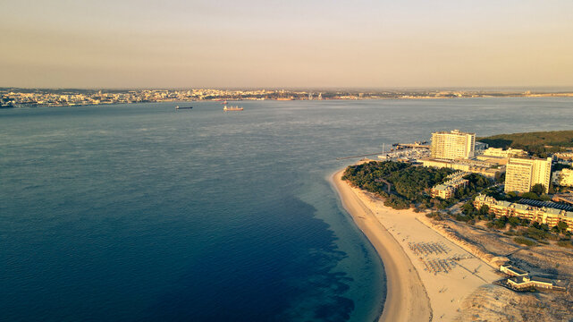 Aerial view of Troia Peninsula luxury resort and coastal dunes at sunset, Setubal, Portugal.