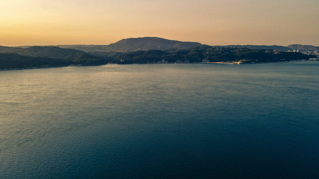 Aerial view of Troia Peninsula luxury resort and coastal dunes at sunset, Setubal, Portugal.