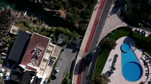 Top down aerial view of outdoor swimming pool and sun loungers in Cascais, Portugal