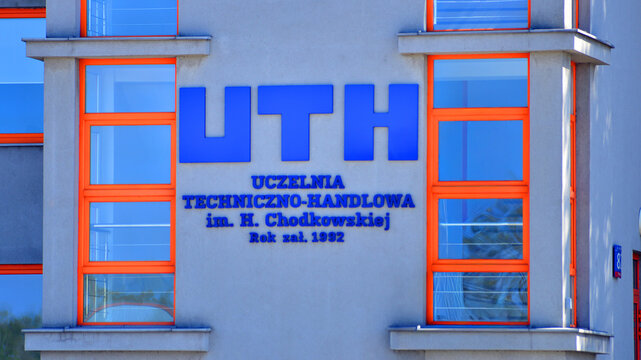 Warsaw, Poland. 21 April 2026. Urban landscape. Neon sign with the inscription: UTH. Uczelnia Techniczno Handlowa