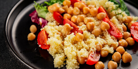 Couscous with chickpeas and vegetables couscous salad main course lunch or dinner tasty snack fresh, delicious, gourmet food background on the table rustic food top view copy space