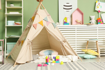 Cute wigwam and building blocks in stylish child's room © New Africa