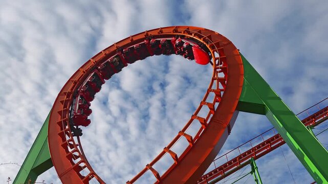 Vibrant roller coaster sends excited passengers through a series of thrilling twists, turns, and a dramatic upside down loop