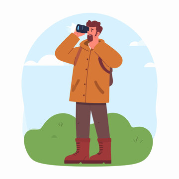 Man looking through binoculars standing.