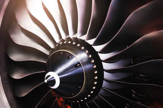 Low pressure compressor of an aircraft gas turbine engine rotates, front view of the turbine with titanium compressor blades.